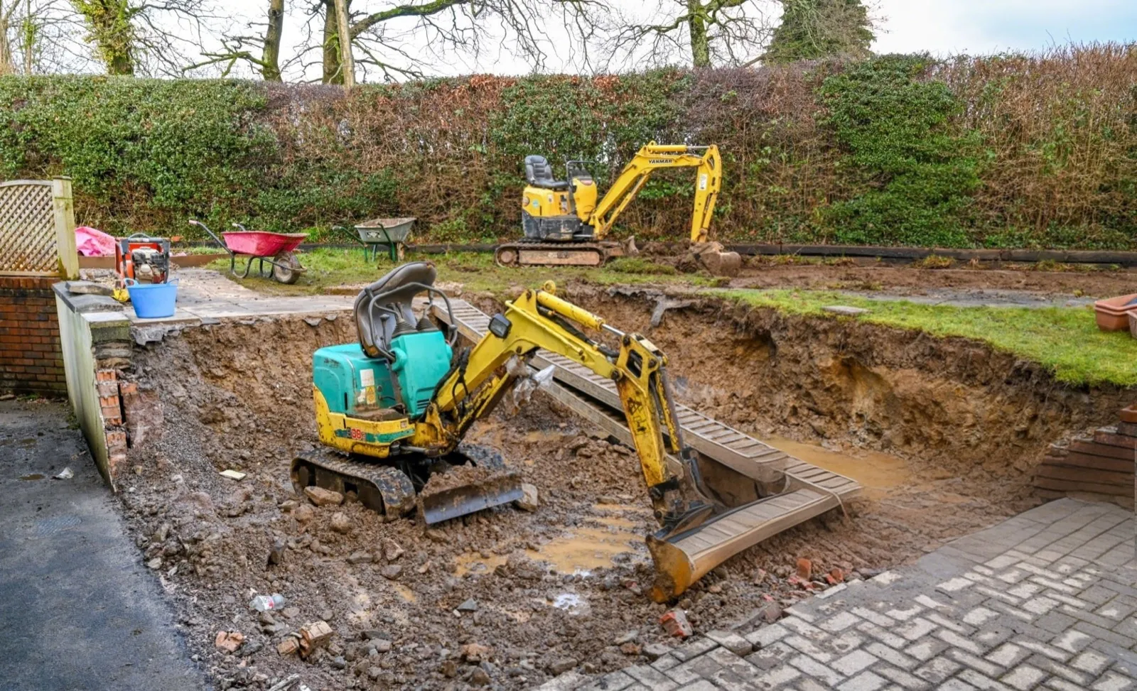 Compact excavator opening a residential dig